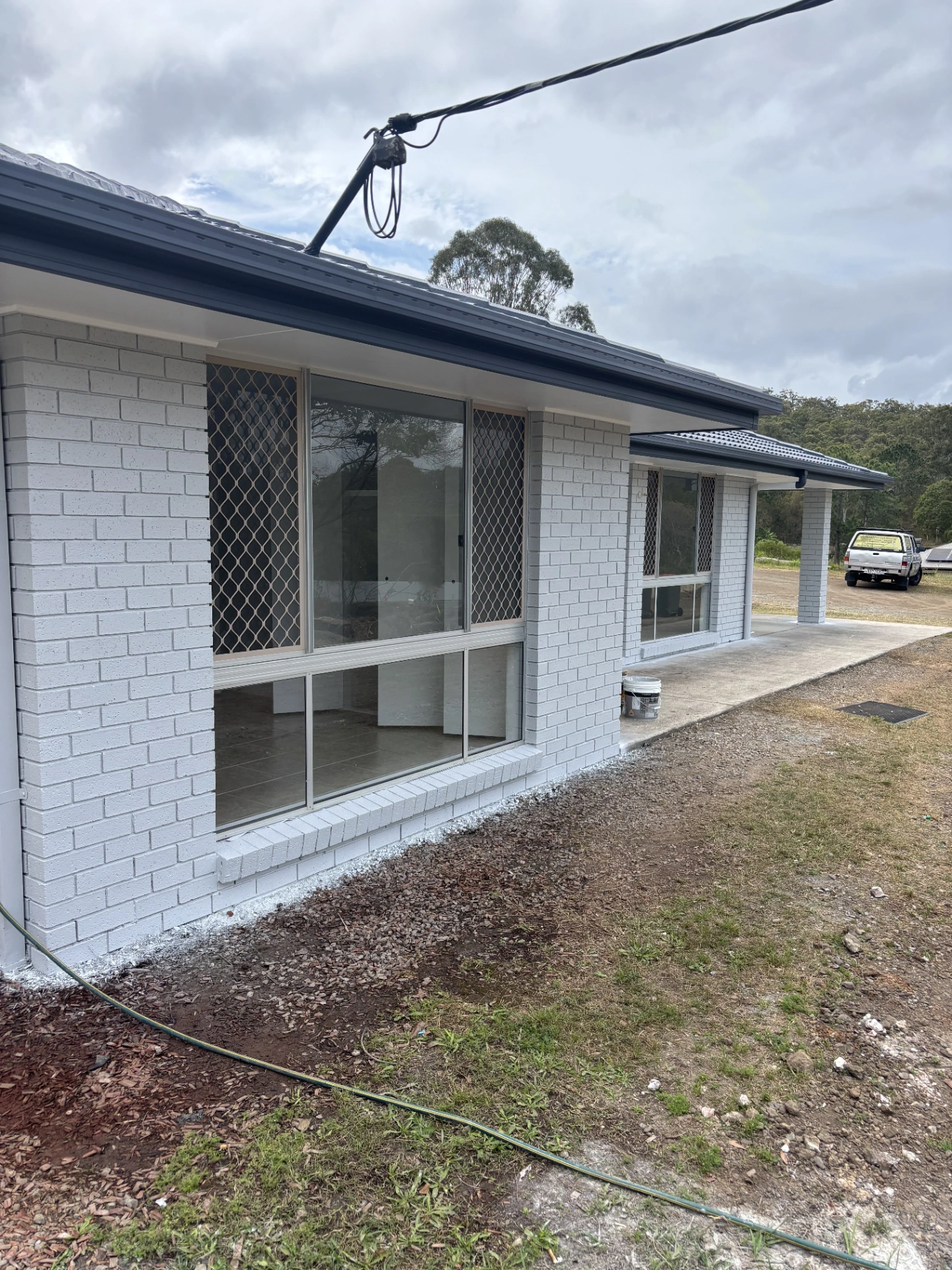 Completed white brick exterior with dark painted trim